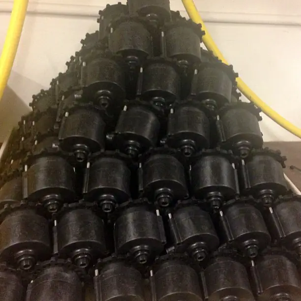 A stacked pyramid of black Breather valve bodies in the Vacless shop