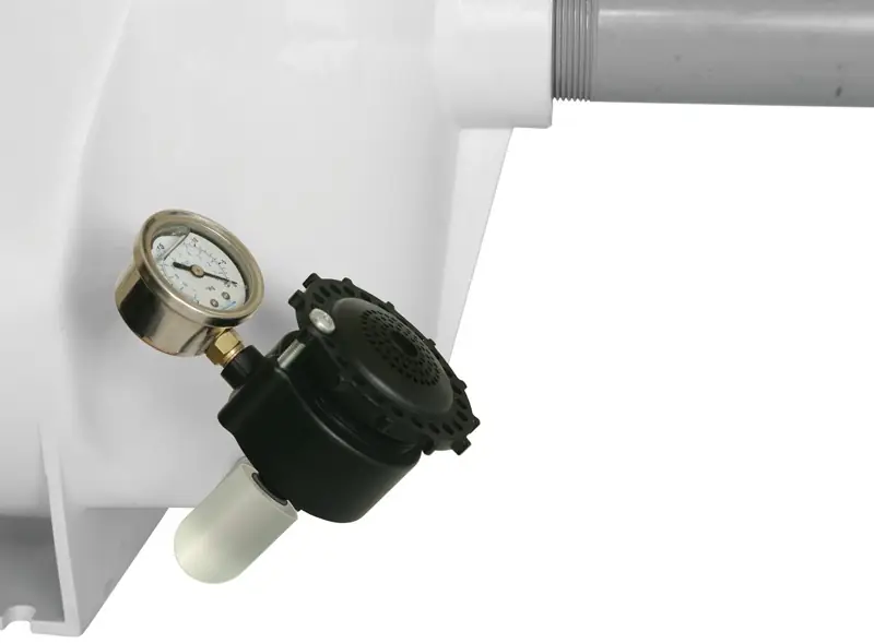Breather valve and vacuum gauge threaded into the drain port of a white pump housing